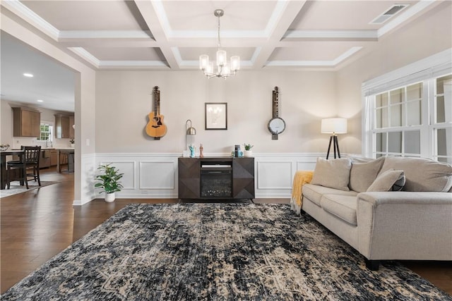 1835 Solamere Ct, Auburn, AL 36832 - living room with a chandelier, beam ceiling, coffered ceiling, dark wood-style flooring, and a wainscoted wall
