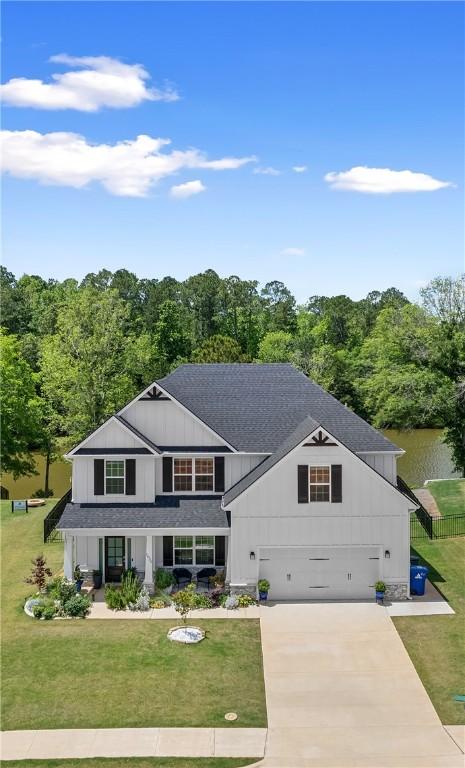 1835 Solamere Ct, Auburn, AL 36832 - view of front of house featuring concrete driveway, board and batten siding, a front yard, and a shingled roof