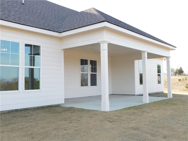 view of home's exterior with a patio area and a lawn