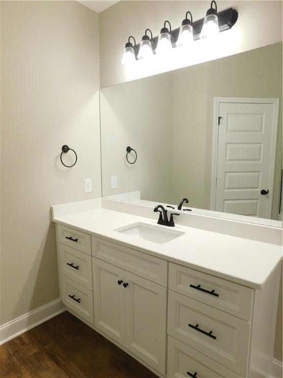 bathroom with vanity and wood-type flooring