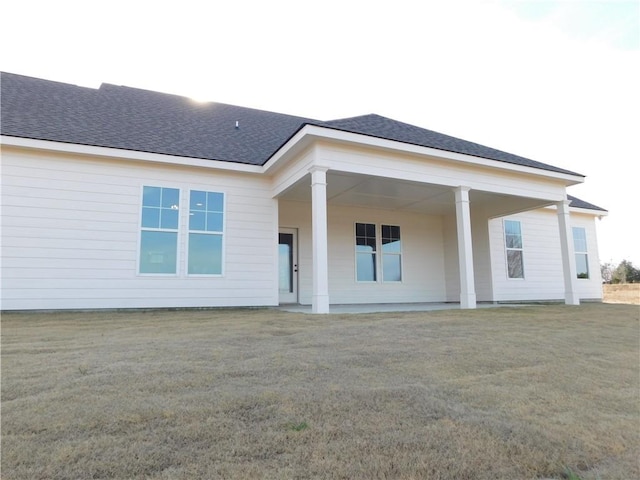 rear view of house with a yard