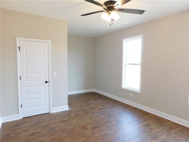 spare room featuring ceiling fan and dark hardwood / wood-style flooring