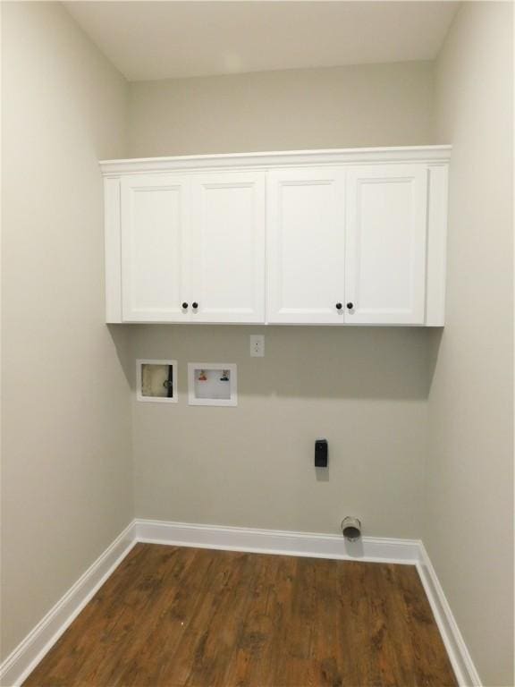 washroom with cabinets, electric dryer hookup, washer hookup, and dark hardwood / wood-style flooring