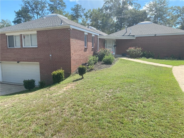 view of home's exterior with a garage and a lawn