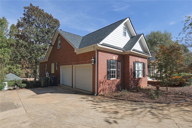 view of side of home with a garage