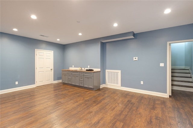 basement featuring dark hardwood / wood-style floors and sink