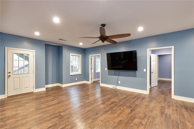 unfurnished living room featuring dark hardwood / wood-style floors and ceiling fan