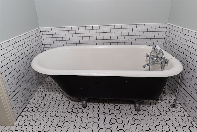 bathroom featuring a bath and tile patterned floors