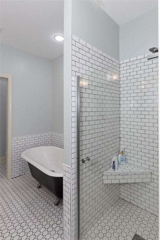 bathroom featuring tile patterned floors and separate shower and tub