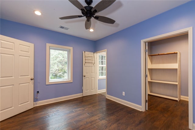 unfurnished bedroom featuring ceiling fan and dark hardwood / wood-style floors