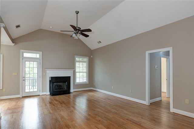 unfurnished living room featuring ceiling fan, light hardwood / wood-style floors, a premium fireplace, and lofted ceiling