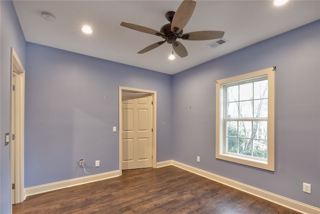 empty room with dark hardwood / wood-style floors and ceiling fan