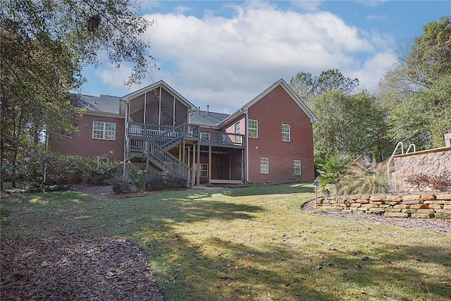 rear view of house featuring a sunroom, a deck, and a lawn