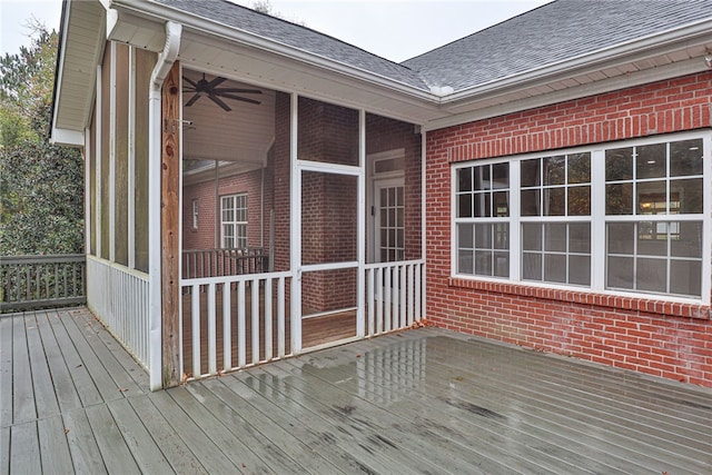 deck featuring ceiling fan and a sunroom