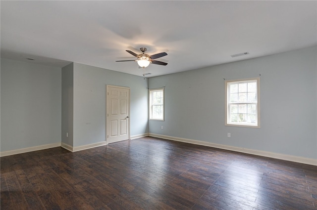 spare room with ceiling fan and dark hardwood / wood-style flooring