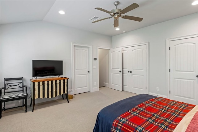 bedroom featuring ceiling fan, light colored carpet, and vaulted ceiling