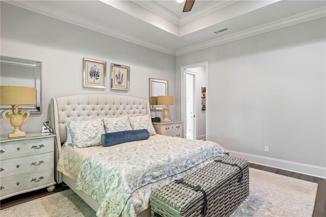 bedroom featuring a raised ceiling, ceiling fan, crown molding, and dark wood-type flooring