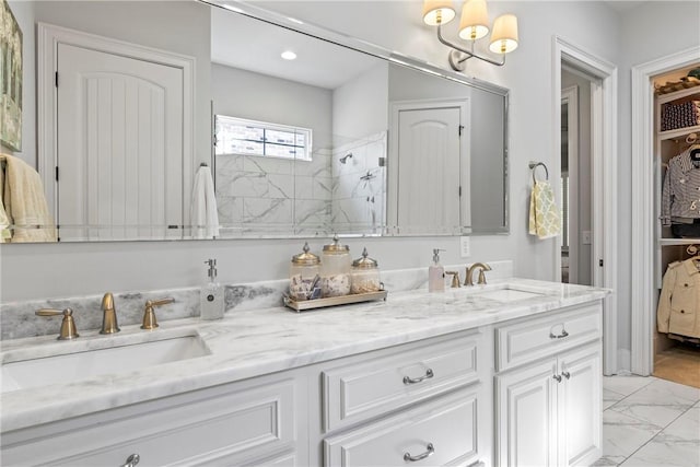 bathroom featuring a tile shower and vanity