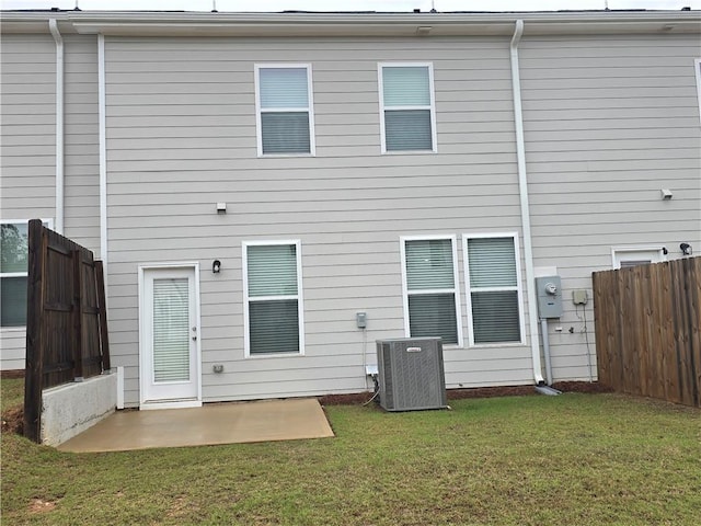 back of property featuring cooling unit, fence, a yard, and a patio