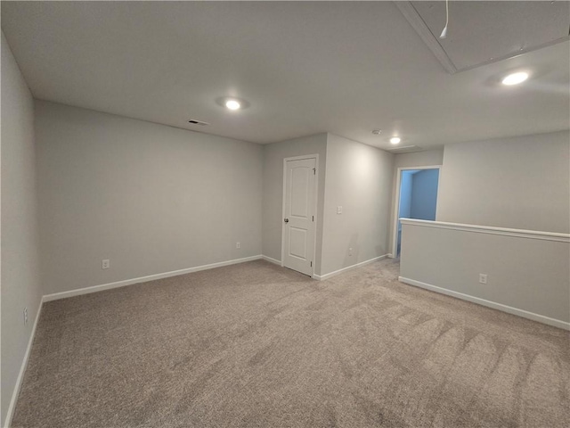 spare room with attic access, light carpet, baseboards, visible vents, and recessed lighting