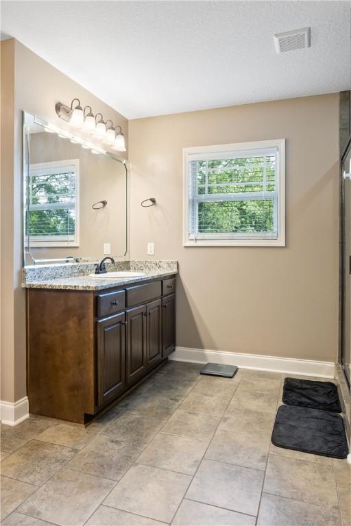2107 Rockledge Cir, Opelika, AL 36801 - bathroom with plenty of natural light, baseboards, and vanity