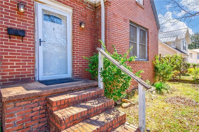 property entrance featuring brick siding