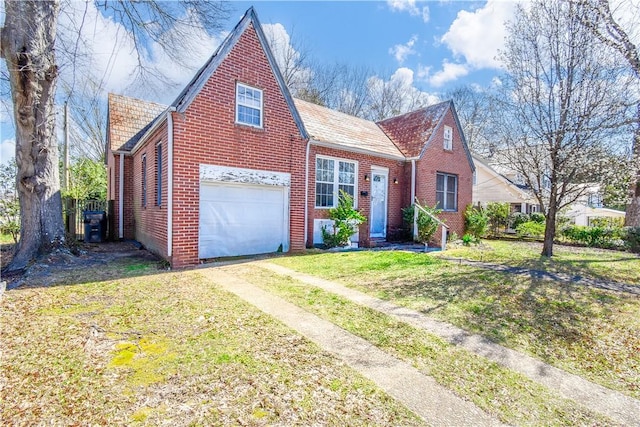 view of front of home with brick siding, driveway, an attached garage, and a front lawn