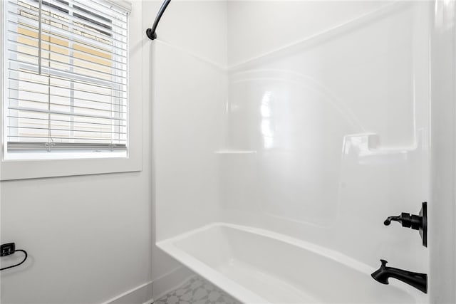 bathroom featuring tub / shower combination and a healthy amount of sunlight