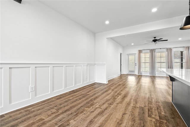 unfurnished living room featuring hardwood / wood-style flooring and ceiling fan