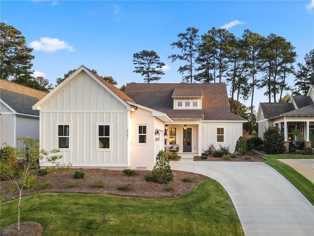 modern inspired farmhouse featuring a front lawn