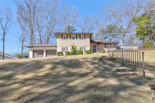 split level home with a garage and a front lawn