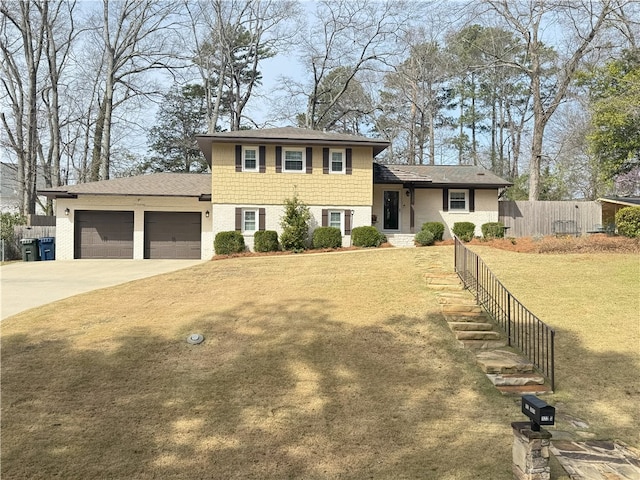 tri-level home featuring driveway, brick siding, an attached garage, fence, and a front yard