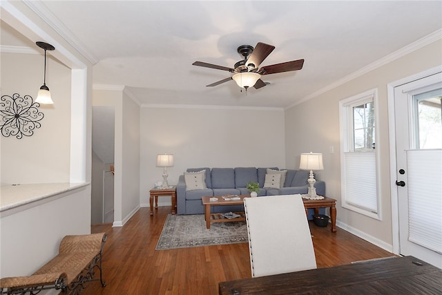 living room with ornamental molding, wood finished floors, a ceiling fan, and baseboards