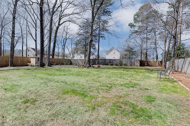 view of yard with an outbuilding and a fenced backyard