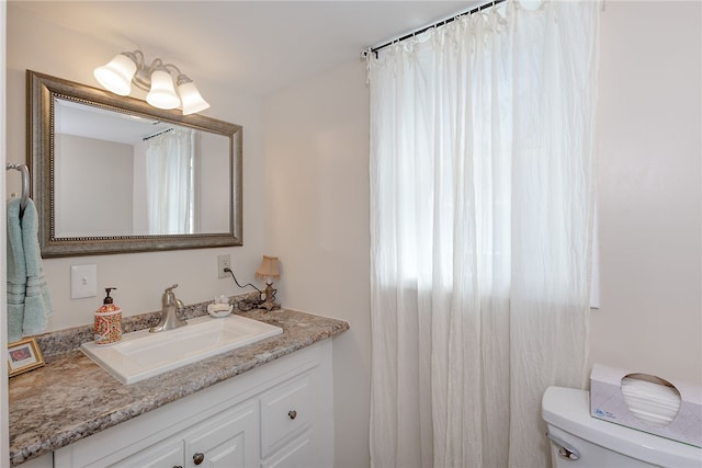 bathroom with toilet and vanity