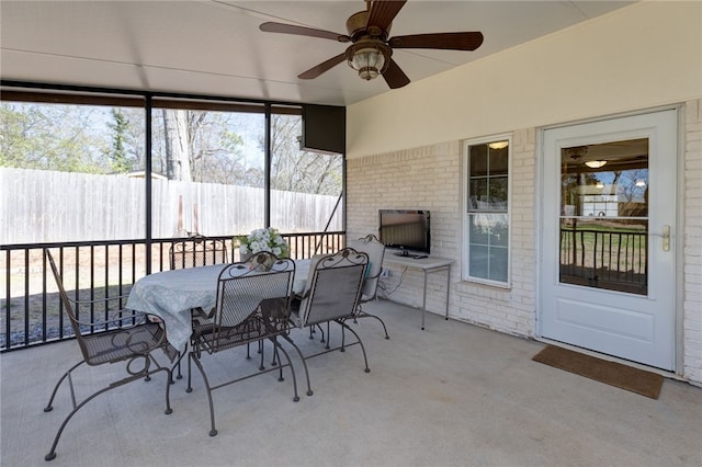 sunroom featuring a ceiling fan