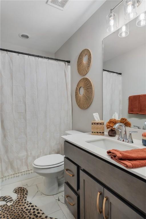 223 Meadowlark Dr, Smiths Station, AL 36877 - full bath featuring vanity, toilet, visible vents, and marble finish floor