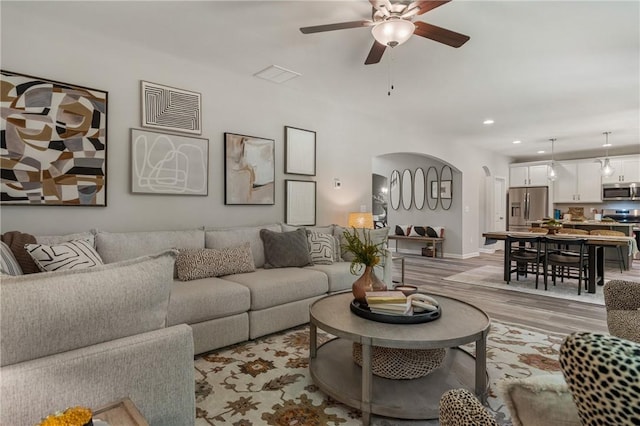 223 Meadowlark Dr, Smiths Station, AL 36877 - living area with visible vents, recessed lighting, arched walkways, ceiling fan, and light wood-style floors
