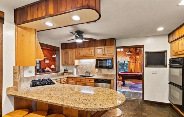 kitchen featuring ceiling fan, sink, stainless steel appliances, billiards, and kitchen peninsula