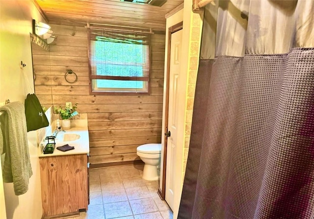 bathroom with vanity, wood walls, toilet, and wooden ceiling