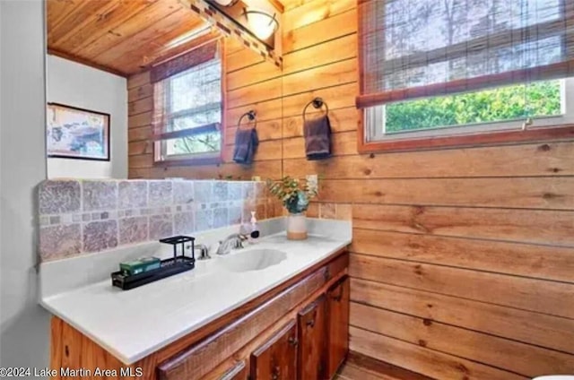 bathroom with vanity, wood walls, and wooden ceiling