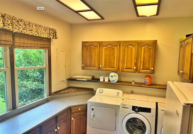 laundry area with cabinets and washing machine and clothes dryer