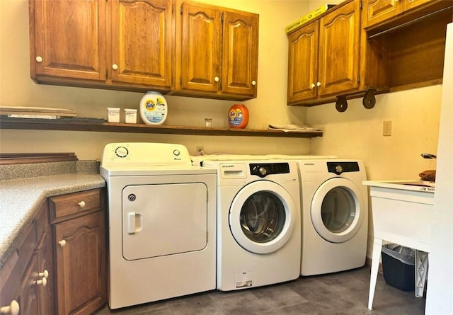 laundry room with washer and clothes dryer and cabinets