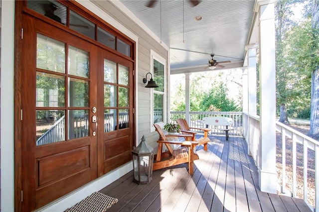 wooden deck featuring french doors, ceiling fan, and a porch