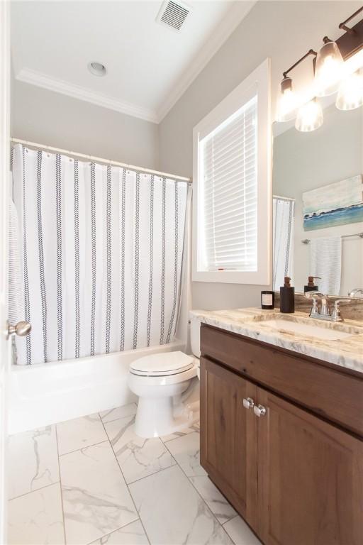 full bathroom with vanity, crown molding, toilet, and shower / tub combo with curtain