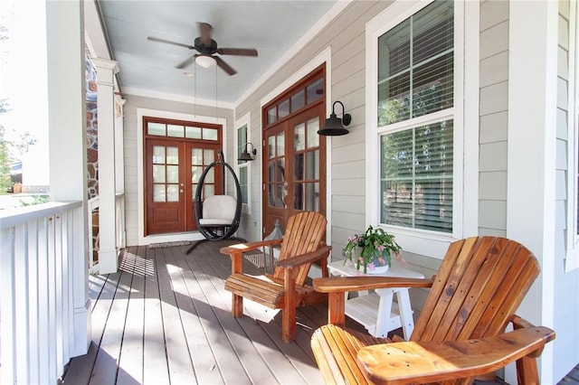 deck with french doors, ceiling fan, and a porch