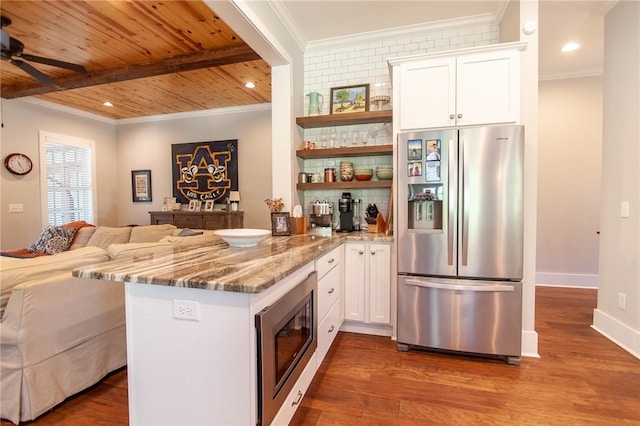 kitchen featuring hardwood / wood-style floors, white cabinets, kitchen peninsula, stainless steel appliances, and light stone countertops