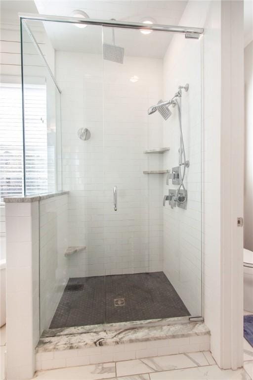 bathroom with toilet and walk in shower