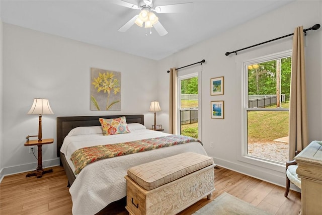bedroom with baseboards, ceiling fan, and wood finished floors