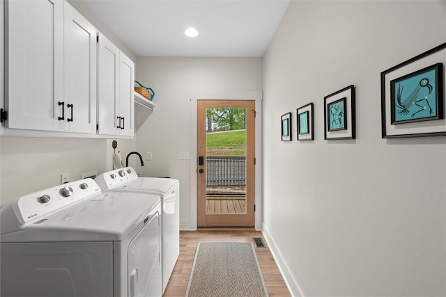 clothes washing area with cabinet space, independent washer and dryer, light wood-style floors, recessed lighting, and baseboards